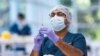 A technician prepares a Pfizer vaccine in the pharmacy area of the newly opened COVID-19 Vaccination Centre in Sydney, Australia, Monday, May 10, 2021. (James Gourley/Pool Photo via AP)