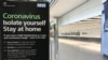 A sign at Heathrow Airport Terminal 5 arrivals warns of Coronavirus, in London, March 24, 2020. 