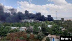 FILE - Smoke billows from the scene of an airstrike in Mekelle, capital of the Tigray region, Ethiopia, Oct. 20, 2021.