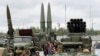 RUSSIA -- Visitors look at Russian tactical ballistic missile OTR-21 Tochka-U (L), 122mm multiple rocket launcher BM-21 Grad (2_L), tactical ballistic missile 9K720 Iskander-M (C) and 300mm multiple rocket launcher BM-30 Smerch (R) during a military exhib