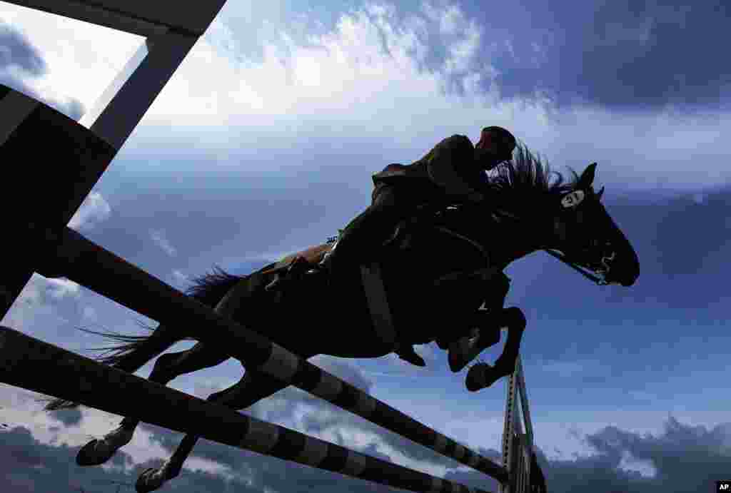 German Josef Fuchs and his horse 'Aragon' clear a hurdle during the fault and style jumping at the 4th International Open German Cavalry Championship in Crawinkel, central Germany.