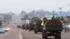 Congo military trucks carrying Congolese troops drive in a main street after violence erupted due to the delay of the presidential elections in Kinshasa, Democratic Republic of Congo, Tuesday, Sept. 20, 2016.