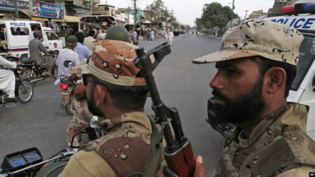 In this picture taken Aug. 1, 2011, Pakistani paramilitary troops patrol a troubled area of Karachi, Pakistan, following weeks of unabated killings