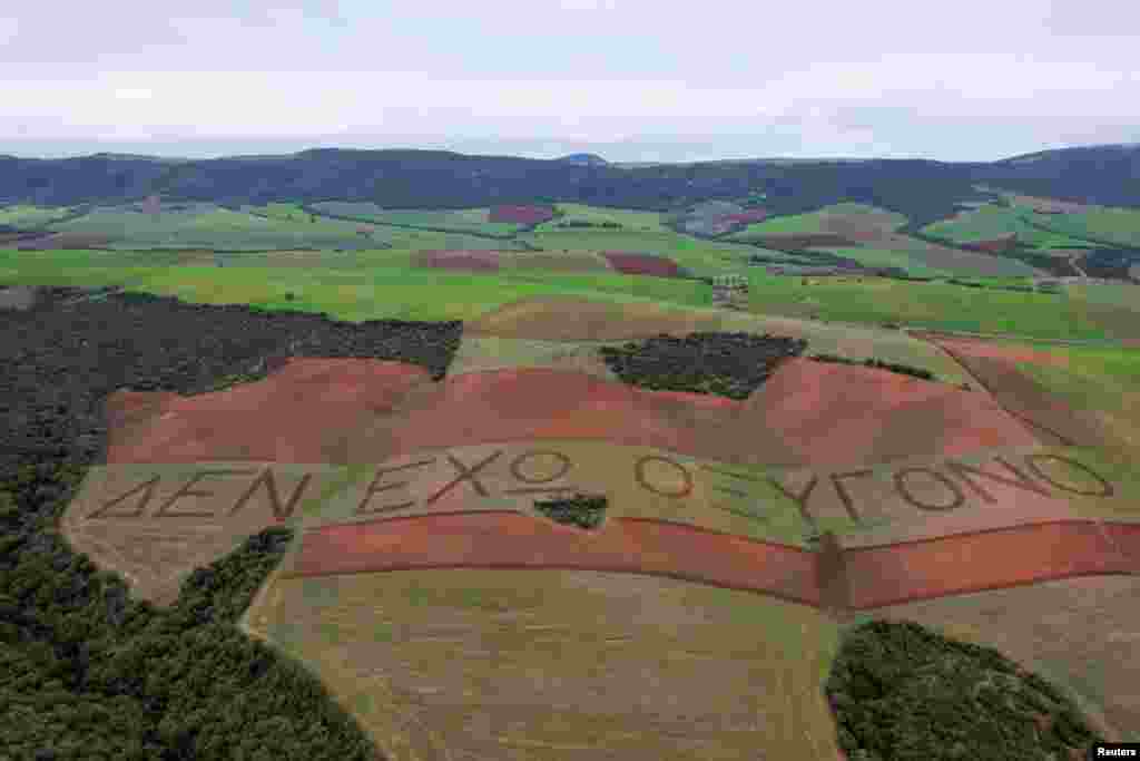 A drone view shows a message plowed across fields reading "I have no oxygen", a phrase a victim of a deadly train accident in 2023 that killed 57 passengers, used in a phone call to the emergency services, in the village of Galarinos, Greece. 