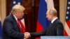 US President Donald J. Trump (L) and Russian President Vladimir Putin (R) shake hands during a joint press conference following their summit talks at the Presidential Palace in Helsinki, Finland, July 16, 2018 