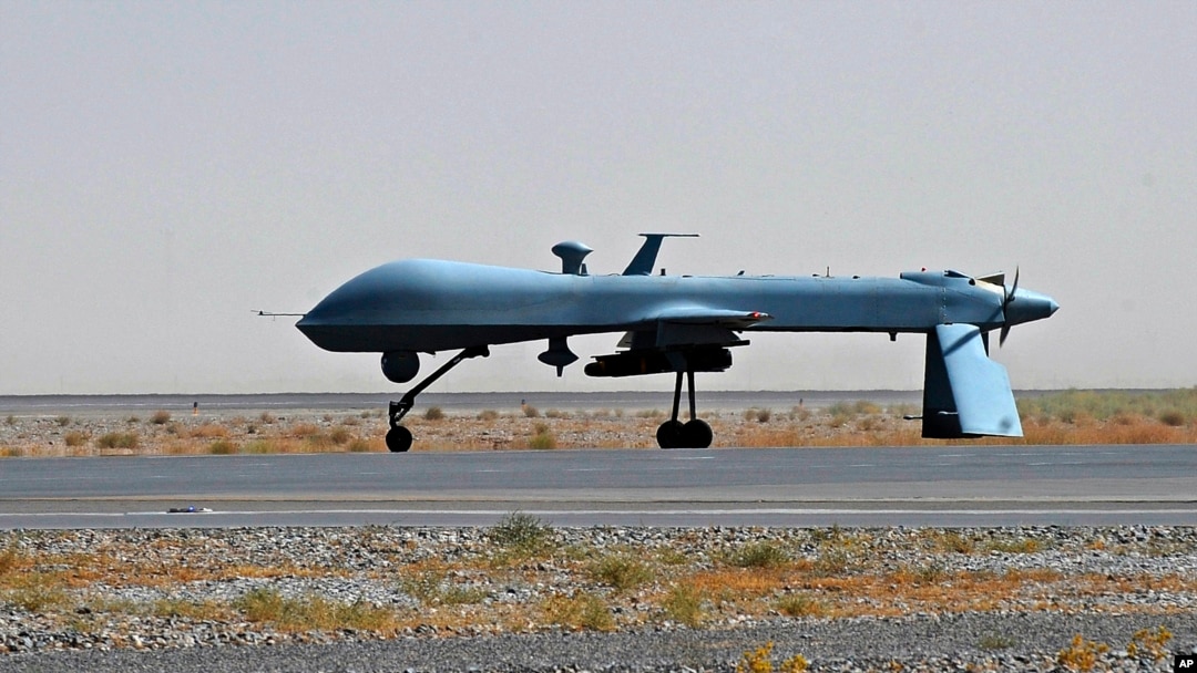 FILE - A U.S. Predator unmanned drone armed with a missile stands on the tarmac of a military airport, June 13, 2010.