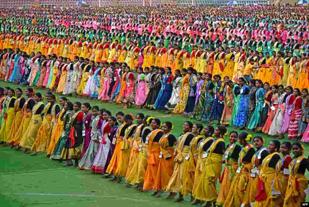 Thousands of dancers perform "jhumur," an Indian folk dance, as they rehearse for the upcoming Jhumur Festival at the Sarusajai Stadium in Guwahati, India.