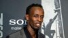 Barkhad Abdi poses for photographers as he walks the red carpet at a screening for the movie "Captain Phillips" at the Newseum in Washington, Oct. 2, 2013.