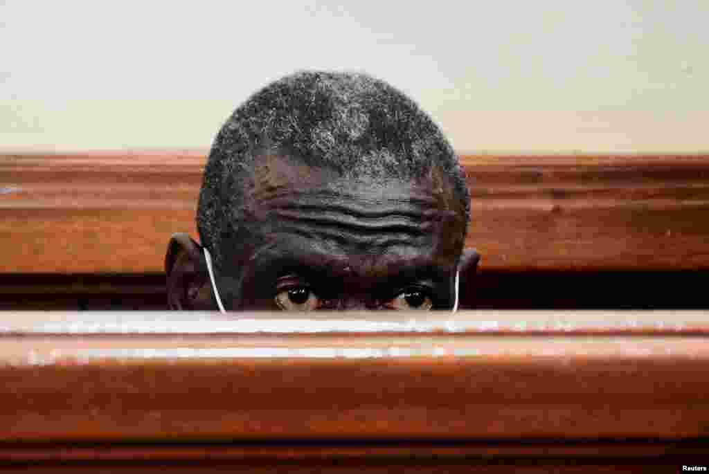Uganda's four-time presidential candidate Kizza Besigye sits in the dock where he was charged with treason, at the Chief Magistrate Court in Nakawa suburb of Kampala, Uganda.