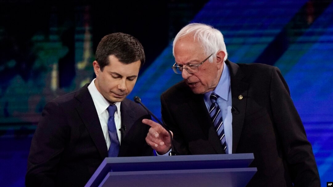 Democratic presidential candidates South Bend Mayor Pete Buttigieg, left, and Sen. Bernie Sanders talk during a break, Sept. 12, 2019, during a Democratic presidential primary debate in Houston.