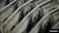 FILE PHOTO: A picture illustration shows U.S. 100 dollar bank notes taken in Tokyo