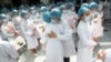 Nurses embrace during a ceremony marking International Nurses Day, at Tongji Hospital in Wuhan, in China&#39;s central Hubei province.