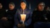 A woman holds a candle as Cardinal Robert Francis Prevost, Prefect of the Dicastery for Bishops, leads the recitation of the Holy Rosary for Pope Francis' health in St Peter's Square at the Vatican, March 3, 2025. 