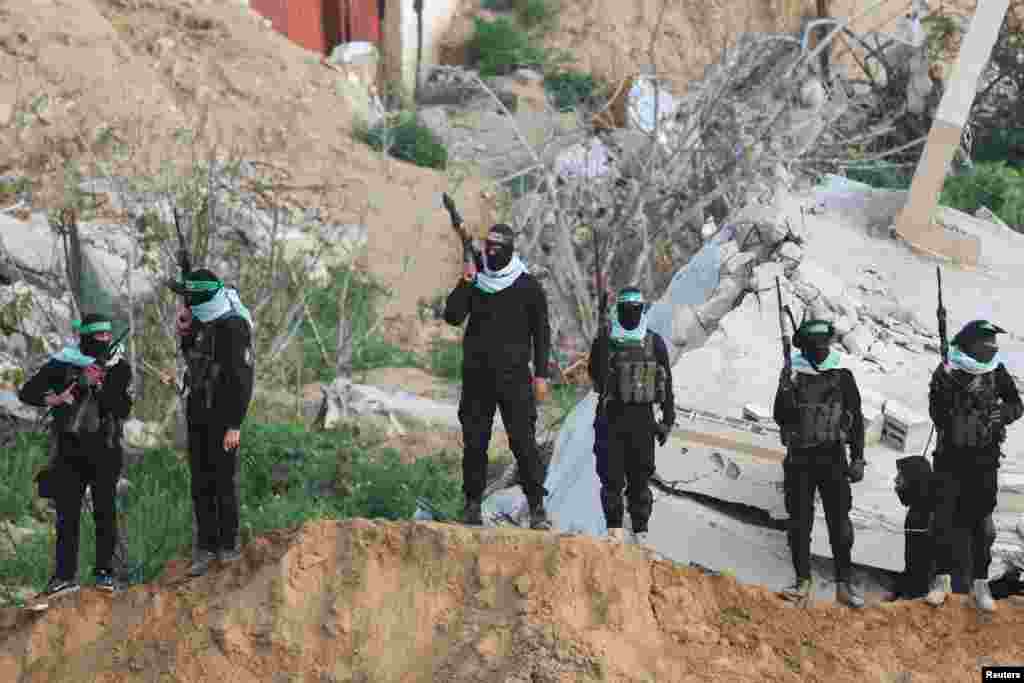 Palestinian Hamas militants keep guard on the day Hamas hands over deceased hostages Oded Lifschitz, Shiri Bibas and her two children Kfir and Ariel Bibas, seized during the deadly October 7, 2023 attack, to the Red Cross, in Khan Younis in the southern Gaza Strip.