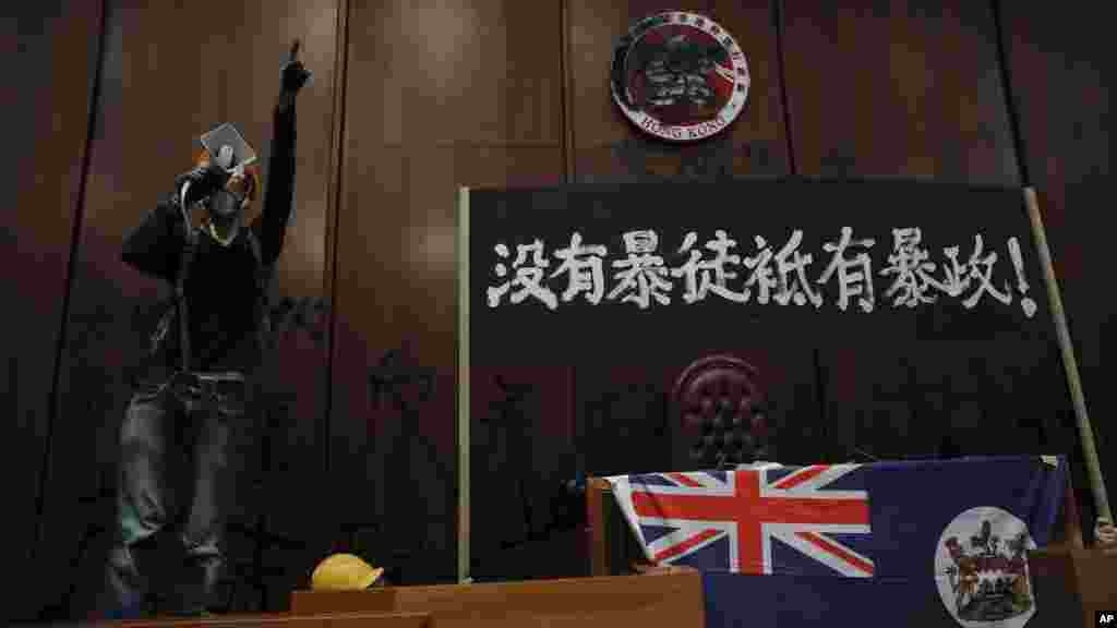 闖入立法會的示威者用噴漆塗黑主席台後的香港特區區徽,放置1997年前的香港殖民地旗,及插上“沒有暴徒只有暴政”的橫額。
