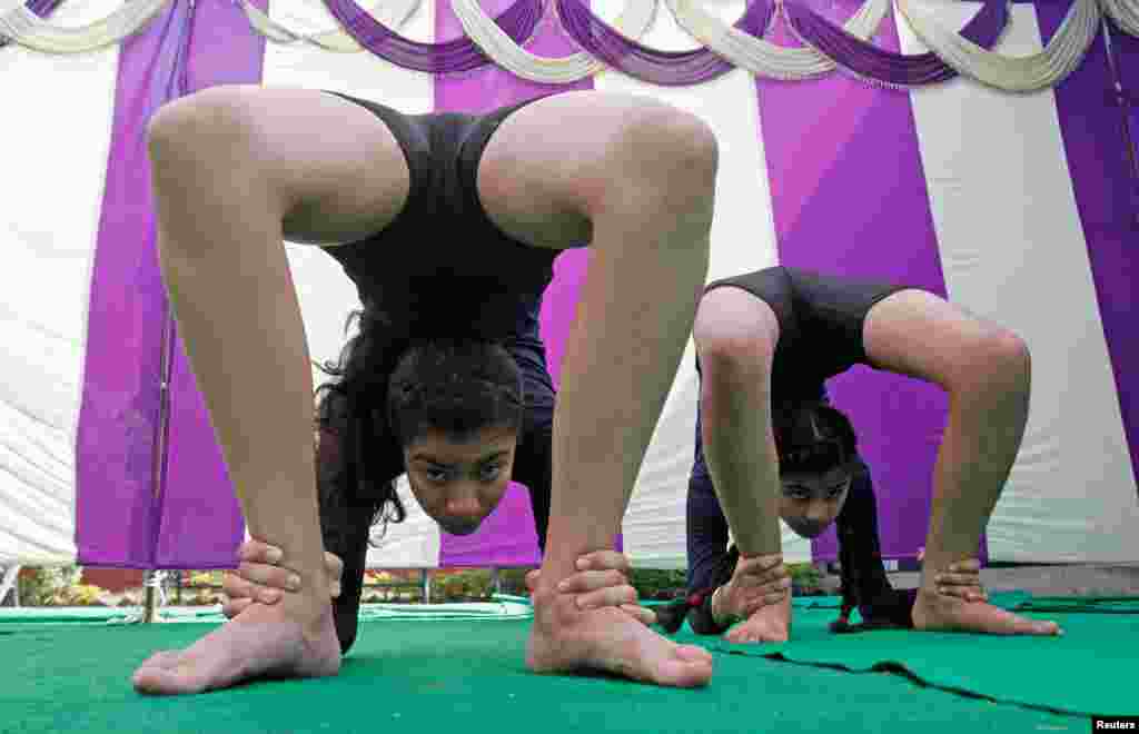Participants perform Shalabhasana, a form of yoga, during a competition in Chandigarh, India.