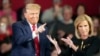 FILE - Republican presidential candidate former President Donald Trump and moderator Laura Ingraham gesture on stage during a Fox News Channel town hall Feb. 20, 2024, in Greenville, SC.