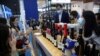 FILE - People taste wines from Australia at the Food and Agricultural Products exhibition at the third China International Import Expo (CIIE) in Shanghai, China, Nov. 5, 2020. 