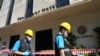 Police forensics team arrive at a hotel in Bangkok, Thailand, Dec. 30, 2024, a day after a fire killed three people. 