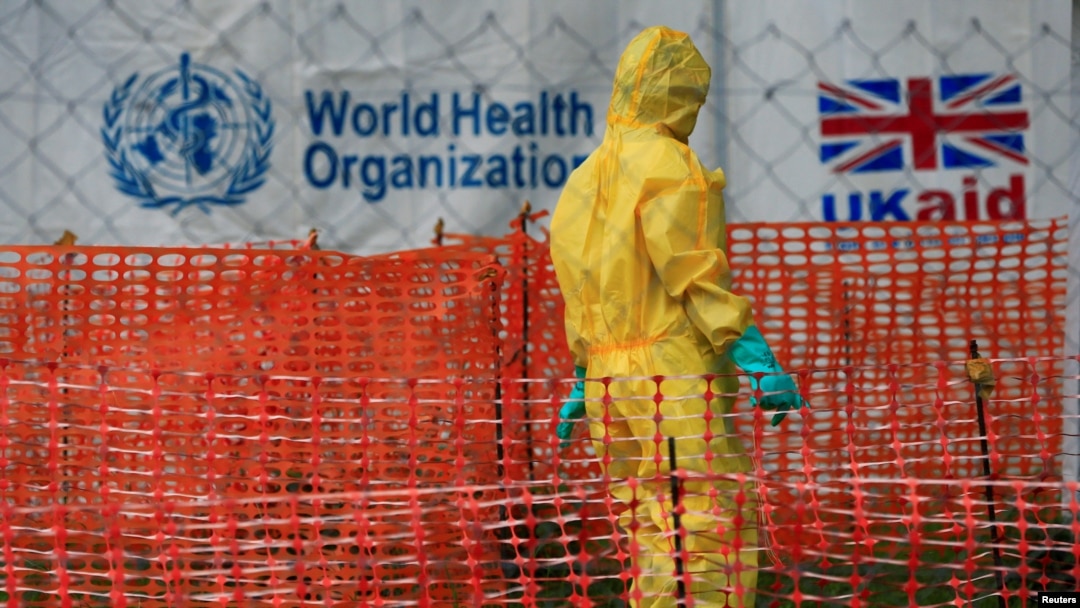FILE - A person dressed in Ebola protective apparel is seen inside an Ebola care facility at the Bwera general hospital near the border with the Democratic Republic of Congo in Bwera, Uganda, June 14, 2019. 