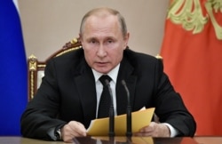 Russian President Vladimir Putin speaks at a meeting with members of the Security Council in the Kremlin in Moscow, Aug. 23, 2019.