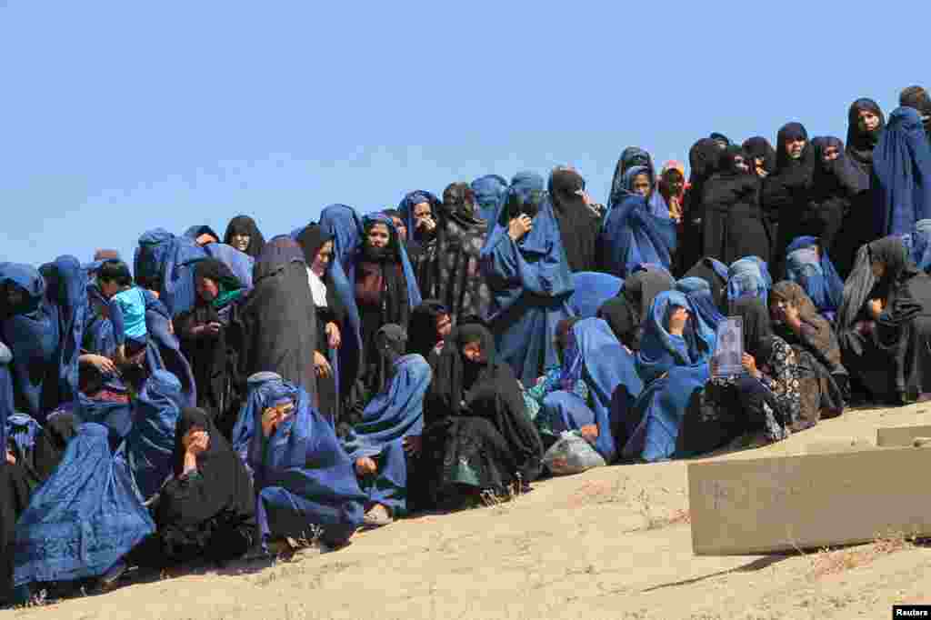 Female Villagers attend the burial ceremony of civilians who were killed by insurgents at Mirza Olang village, in Sar-e Pul province, Afghanistan.