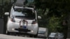 FILE - An autonomous self-driving vehicle goes onto the road during a demonstration in Singapore, Oct. 12, 2015.