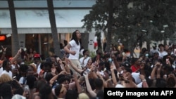 MIAMI BEACH, FLORIDA - MARCH 19: People enjoy themselves along Ocean Drive on March 19, 2021 in Miami Beach, Florida. College students have arrived in the South Florida area for the annual spring break ritual. City officials are concerned with large…