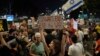 A demonstrator holds a sign about the killing of Hamas leader Yahya Sinwar during a protest calling for a cease-fire deal and the immediate release of hostages held by Hamas on Oct. 17, 2024, in Tel Aviv, Israel.