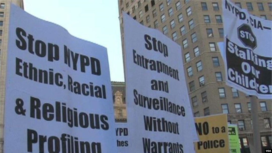 Signs carried by protesters call for end to spying.
