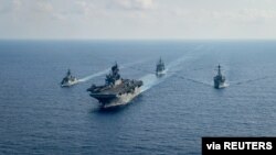 Royal Australian Navy guided-missile frigate HMAS Parramatta (FFH 154) (L) sails with U.S. Navy Amphibious assault ship USS America (LHA 6), Ticonderoga-class guided-missile cruiser USS Bunker Hill (CG 52) and Arleigh-Burke class guided missile destroyer.