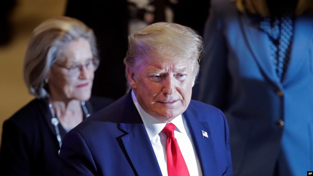 FILE - U.S. President Donald Trump flashes a thumbs-up as he arrives at the World Economic Forum in Davos, Switzerland, Jan. 22, 2020.
